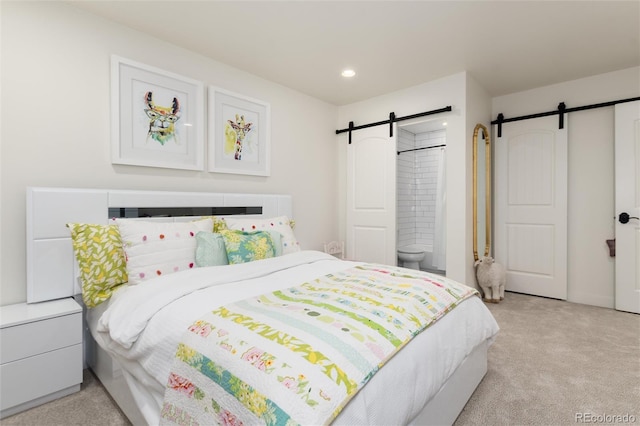1 Club Ln, Littleton, CO 80123 - bedroom featuring a barn door, light colored carpet, recessed lighting, and ensuite bathroom
