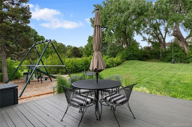 1 Club Ln, Littleton, CO 80123 - wooden deck with outdoor dining space, a lawn, a playground, and view of scattered trees
