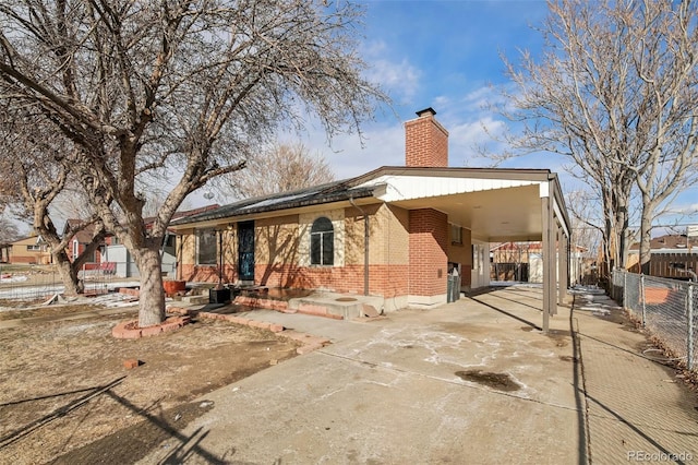 back of property with a carport