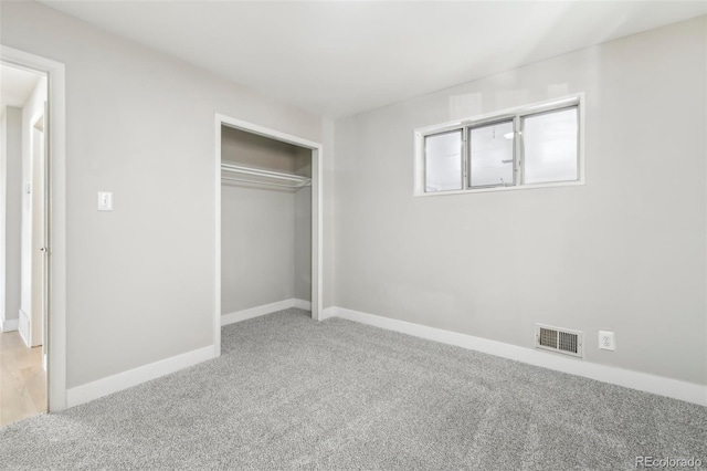 unfurnished bedroom featuring carpet and a closet