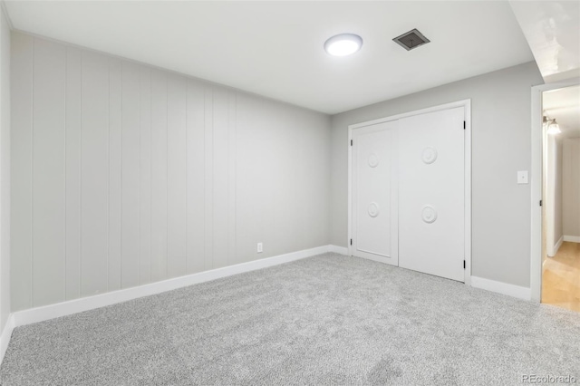 unfurnished bedroom featuring light carpet