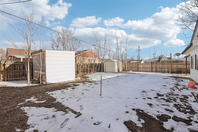 snowy yard with a shed