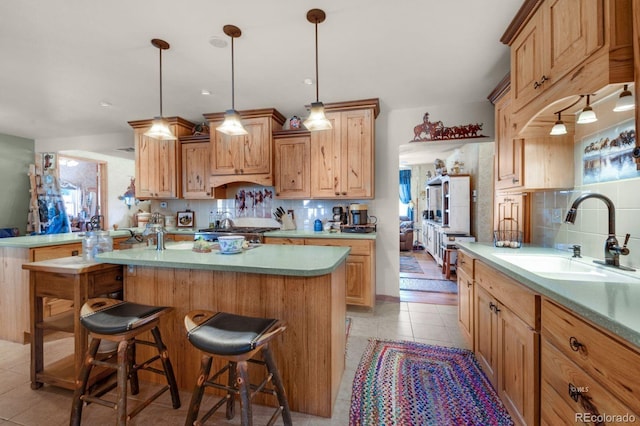 kitchen with decorative backsplash, light tile patterned floors, a healthy amount of sunlight, and sink