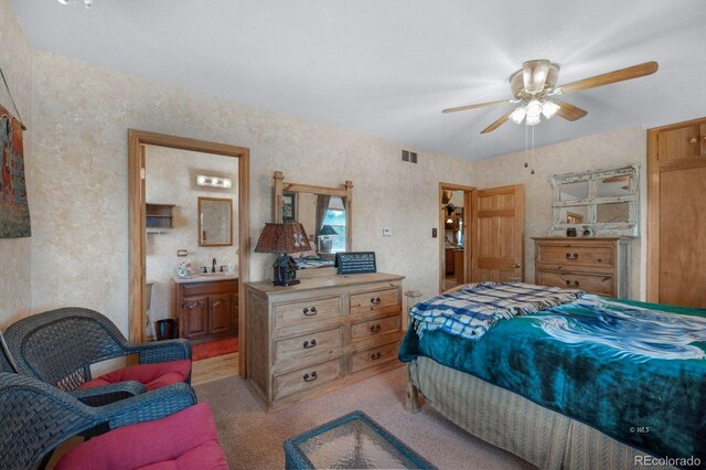 bedroom with sink, light carpet, ceiling fan, and connected bathroom