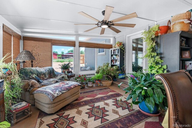 sunroom / solarium featuring ceiling fan