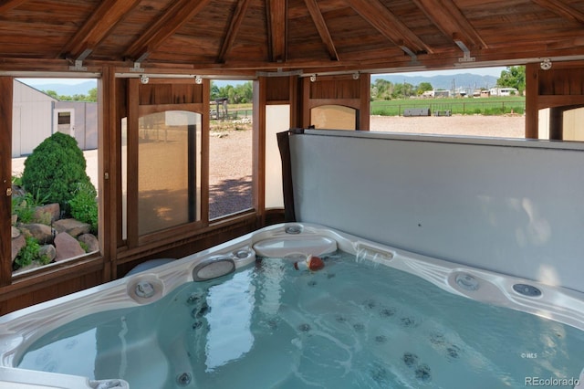 view of swimming pool featuring a hot tub and a gazebo