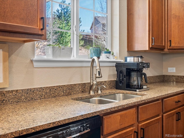 2853 Black Canyon Way, Castle Rock, CO 80109 - kitchen featuring light stone countertops, black dishwasher, a sink, brown cabinets, and a textured wall