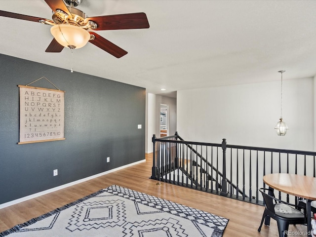2853 Black Canyon Way, Castle Rock, CO 80109 - interior space with wood finished floors, ceiling fan, baseboards, and an upstairs landing