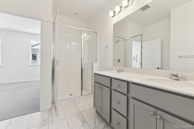 bathroom featuring marble finish floor, a shower stall, visible vents, and a sink