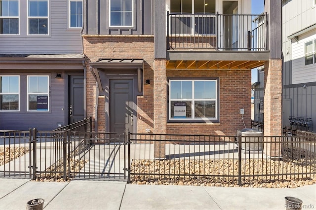 exterior space with brick siding and a fenced front yard