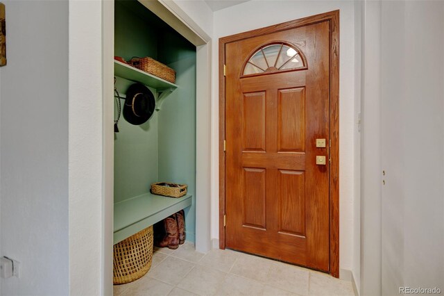 mudroom featuring light tile patterned floors and baseboards