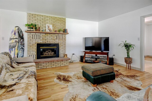 living area with wood finished floors and a fireplace