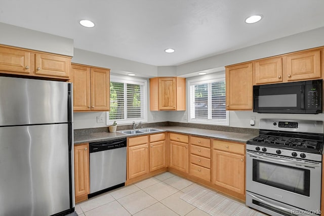 1720 S Madison St, Denver, CO 80210 - kitchen featuring appliances with stainless steel finishes, dark countertops, light tile patterned flooring, light brown cabinets, and recessed lighting
