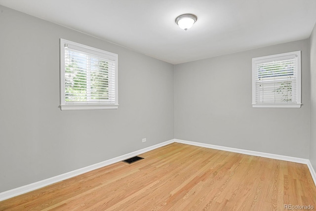 1720 S Madison St, Denver, CO 80210 - empty room featuring baseboards and light wood-style flooring