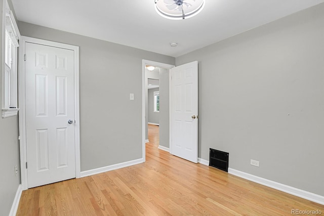 1720 S Madison St, Denver, CO 80210 - unfurnished bedroom with light wood-style flooring and a chandelier