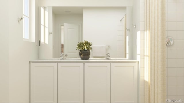 1159 Redfish Pt, Colorado Springs, CO 80904 - bathroom featuring double vanity and a shower with shower curtain