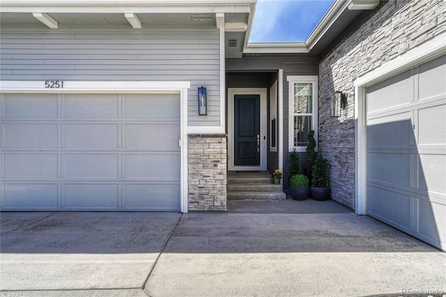 5251 Silver Hare Ct, Castle Rock, CO 80104 - doorway to property with concrete driveway, stone siding, and a garage