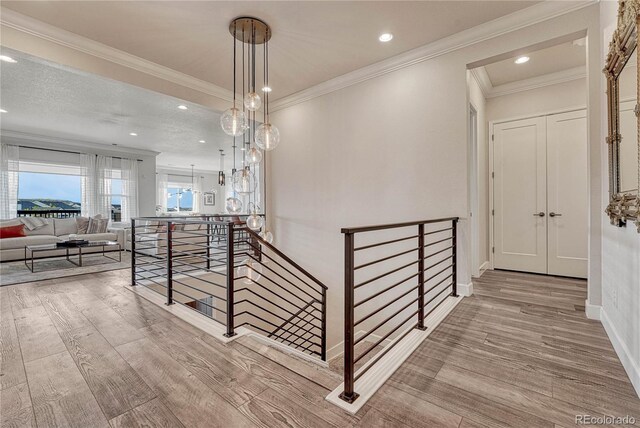 5251 Silver Hare Ct, Castle Rock, CO 80104 - hall featuring crown molding, recessed lighting, an upstairs landing, and wood finished floors