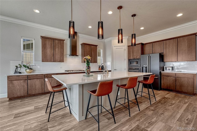 5251 Silver Hare Ct, Castle Rock, CO 80104 - kitchen featuring backsplash, appliances with stainless steel finishes, light wood-style flooring, and a breakfast bar area
