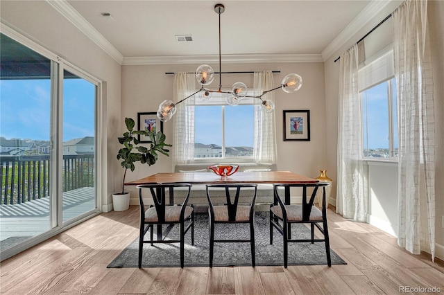 5251 Silver Hare Ct, Castle Rock, CO 80104 - dining space featuring a healthy amount of sunlight, an inviting chandelier, and wood finished floors