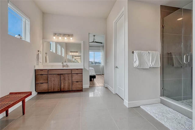 5251 Silver Hare Ct, Castle Rock, CO 80104 - ensuite bathroom featuring baseboards, tile patterned floors, a shower stall, and a healthy amount of sunlight