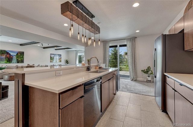 5251 Silver Hare Ct, Castle Rock, CO 80104 - kitchen with a kitchen island with sink, light colored carpet, a sink, open floor plan, and stainless steel appliances