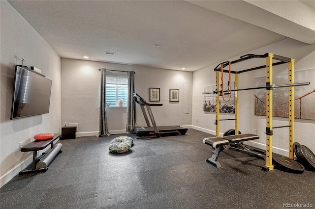 5251 Silver Hare Ct, Castle Rock, CO 80104 - workout area with visible vents, a textured wall, and baseboards