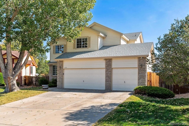 view of front facade featuring a garage and a front lawn