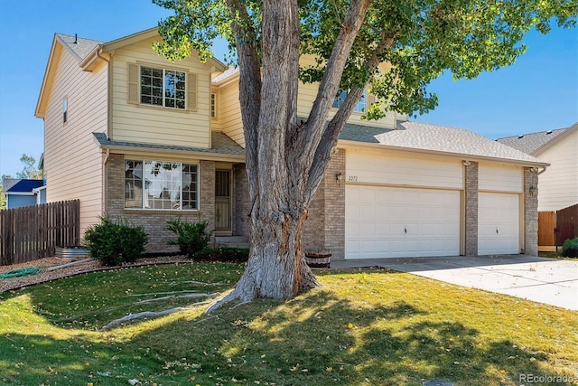 view of front of property with a garage and a front lawn