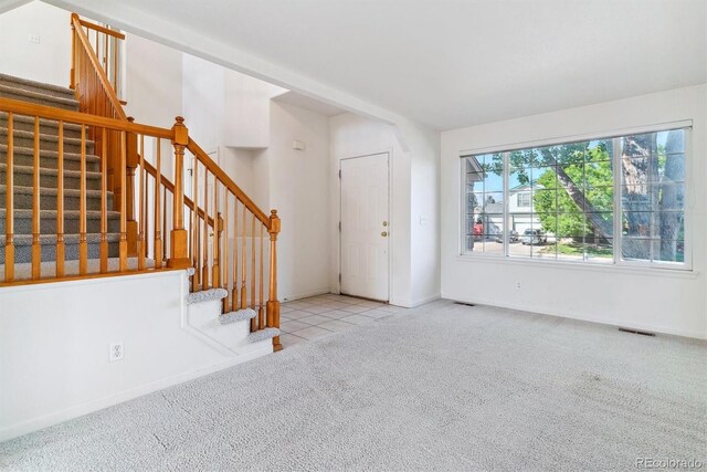 view of carpeted foyer