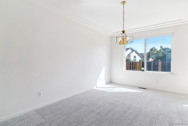 unfurnished room featuring a notable chandelier, light carpet, and crown molding