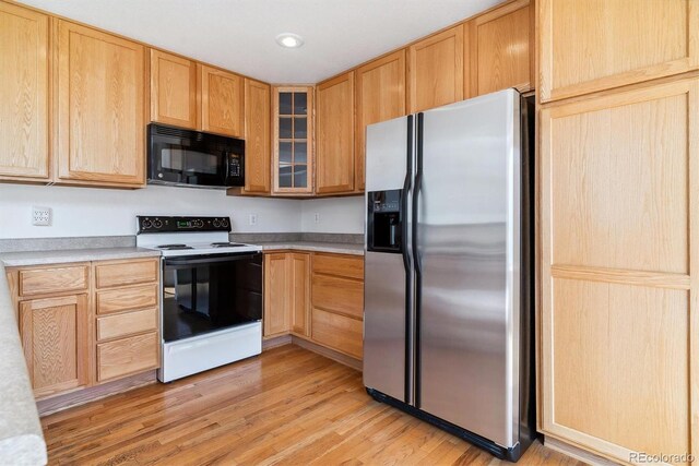 kitchen featuring light brown cabinets, white electric range, light wood-type flooring, and stainless steel fridge with ice dispenser