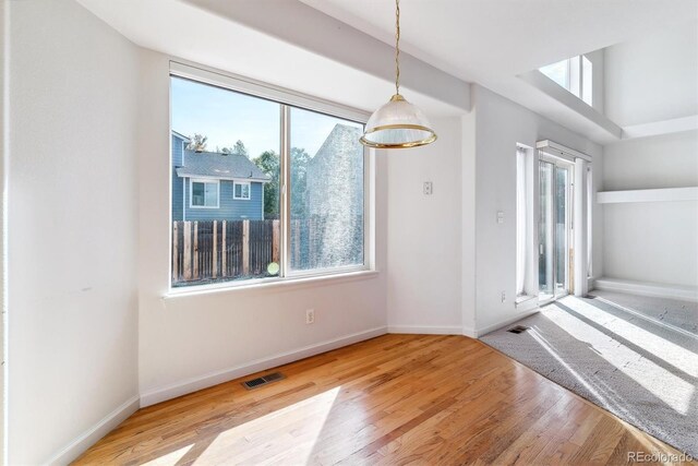 unfurnished dining area featuring hardwood / wood-style flooring