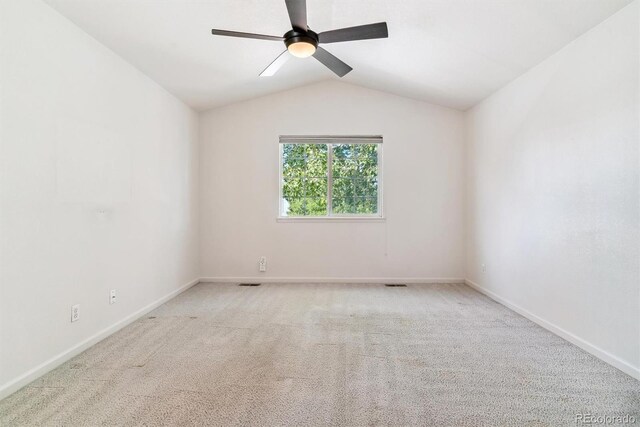 carpeted empty room featuring lofted ceiling and ceiling fan