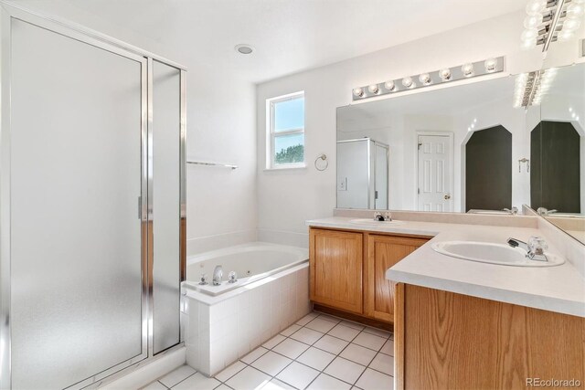 bathroom with tile patterned floors, vanity, and independent shower and bath