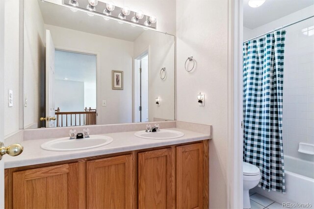 full bathroom with tile patterned floors, toilet, shower / tub combo, and vanity