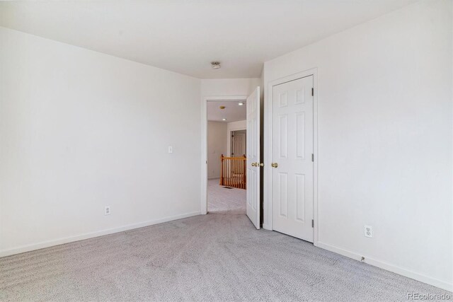 empty room featuring light carpet