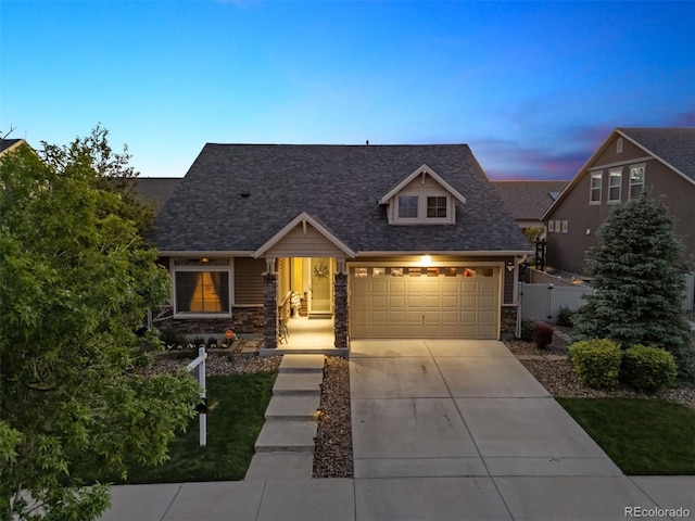 5471 Ensenada Ct, Denver, CO 80249 - view of front of property with concrete driveway, stone siding, and roof with shingles