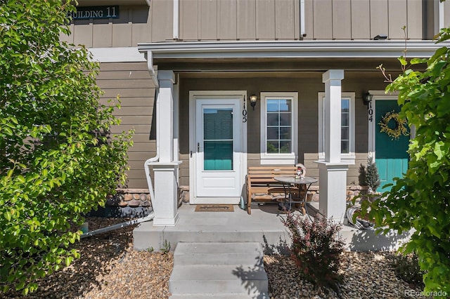 14700 E 104th Ave Unit 1105, Commerce City, CO 80022 - entrance to property with a porch and board and batten siding
