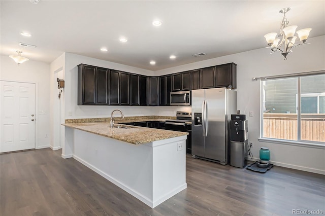 14700 E 104th Ave Unit 1105, Commerce City, CO 80022 - kitchen featuring appliances with stainless steel finishes, a sink, a peninsula, dark wood-type flooring, and recessed lighting