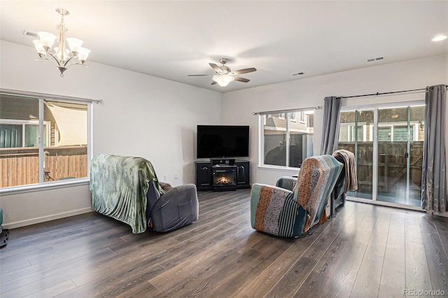 14700 E 104th Ave Unit 1105, Commerce City, CO 80022 - living room with a chandelier, dark wood-type flooring, a ceiling fan, and baseboards