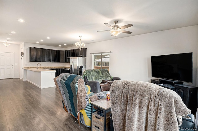 14700 E 104th Ave Unit 1105, Commerce City, CO 80022 - living room featuring ceiling fan, dark wood-type flooring, a chandelier, recessed lighting, and baseboards