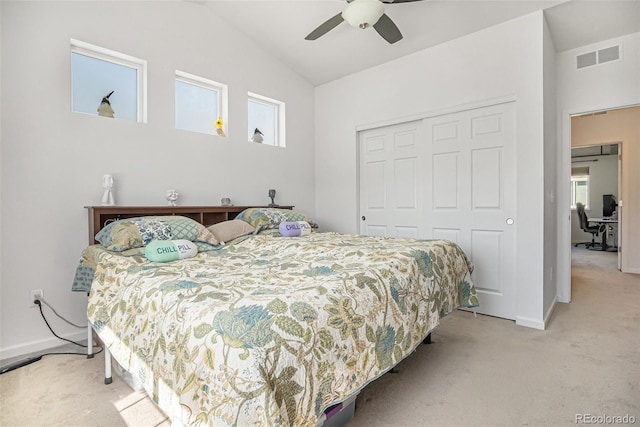 14700 E 104th Ave Unit 1105, Commerce City, CO 80022 - bedroom with light colored carpet, a closet, vaulted ceiling, a ceiling fan, and baseboards