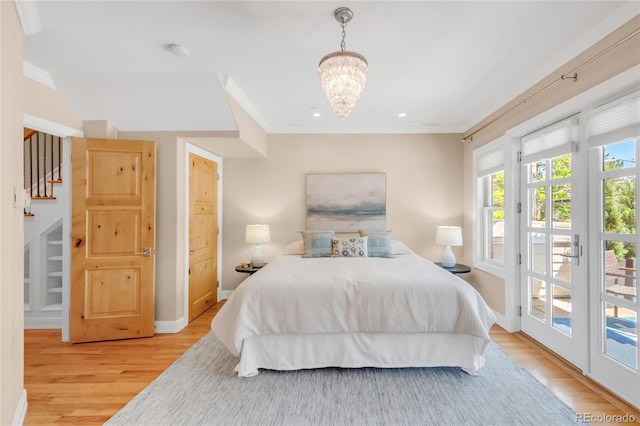 1824 Pearl St Unit B, Boulder, CO 80302 - bedroom with access to outside, light wood-style floors, a chandelier, ornamental molding, and recessed lighting