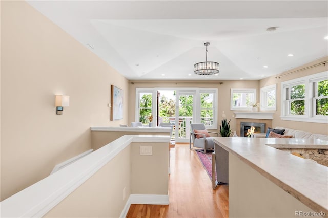 1824 Pearl St Unit B, Boulder, CO 80302 - kitchen with light wood-type flooring, a glass covered fireplace, light countertops, open floor plan, and recessed lighting