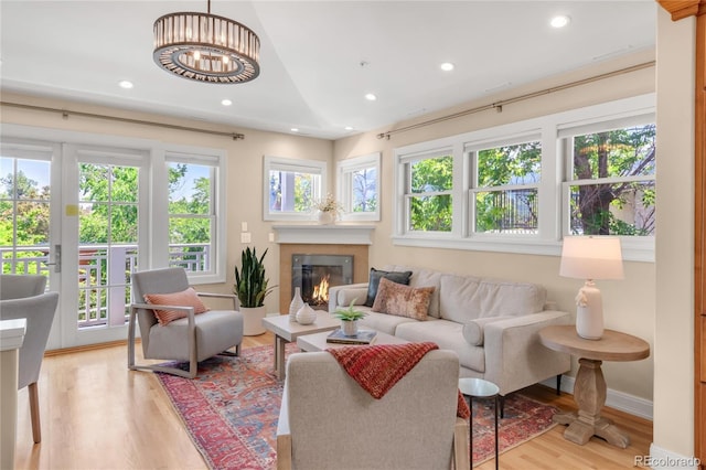 1824 Pearl St Unit B, Boulder, CO 80302 - living area featuring light wood-type flooring, recessed lighting, a glass covered fireplace, and a chandelier