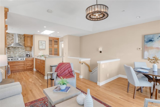 1824 Pearl St Unit B, Boulder, CO 80302 - living room featuring light wood-style floors, a skylight, recessed lighting, and a chandelier