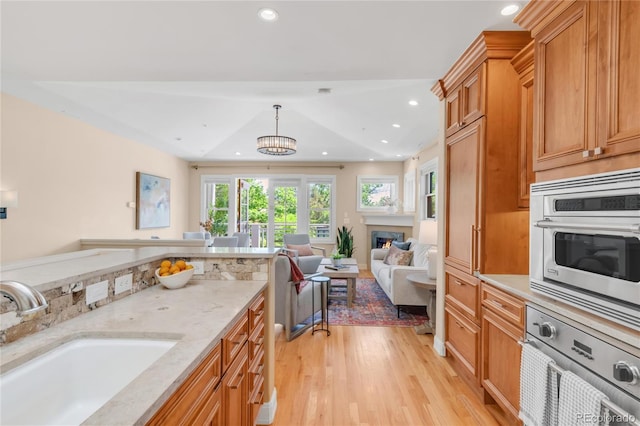 1824 Pearl St Unit B, Boulder, CO 80302 - kitchen featuring stainless steel oven, open floor plan, light wood-style flooring, light stone counters, and recessed lighting