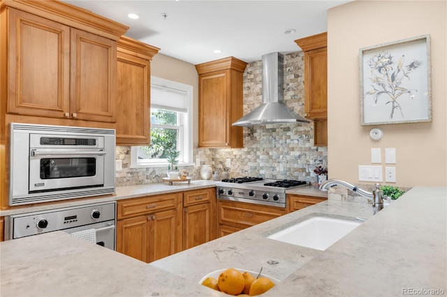 1824 Pearl St Unit B, Boulder, CO 80302 - kitchen featuring wall chimney exhaust hood, stainless steel appliances, decorative backsplash, light stone countertops, and recessed lighting