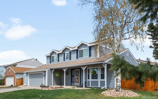 12945 E Colorado Ave, Aurora, CO 80012 - traditional home featuring a garage, a porch, driveway, and a front yard
